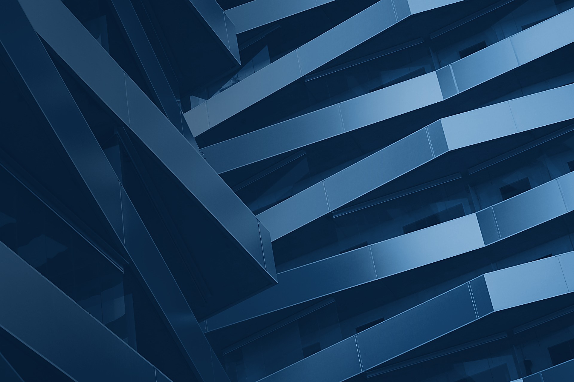Angled balconies and glass railings on a modern building façade